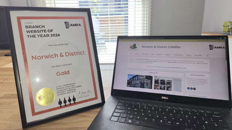 Website of the Year certificate and the site itself on a laptop